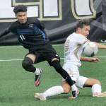Peninsulas Konrad Muller, right, makes a sliding tackle on Clarks Yojany Espiritu on Saturday in Port Angeles. (Keith Thorpe/Peninsula Daily News)