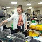 Clallam County election worker Savannah Wise of Port Angeles collects sorted general election ballots for counting at the Clallam County Courthouse in Port Angeles on Tuesday. Full stories on results will be in Thursdays edition. (Keith Thorpe/Peninsula Daily News)