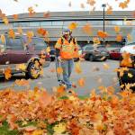 Port Angeles Parks and Recreation Department worker Easton Joslin clears leaves from the parking lot in front of Port Angeles City Hall. As autumn foliage passes its peak of color across the North Olympic Peninsula, so follows the inevitable falling of leaves across the landscape. (Keith Thorpe/Peninsula Daily News)
