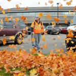 Port Angeles Parks and Recreation Department worker Easton Joslin clears leaves from the parking lot in front of Port Angeles City Hall. As autumn foliage passes its peak of color across the North Olympic Peninsula, so follows the inevitable falling of leaves across the landscape. (Keith Thorpe/Peninsula Daily News)