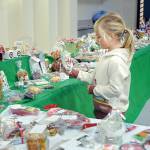 KEITH THORPE/PENINSULA DAILY NEWS 

Six-year-old Baylee Spence of Port Angeles looks over holiday confections at the Original Christmas Cottage craft and gift fair on Friday at Vern Burton Community Center, 308 E. Fourth St., in Port Angeles. The annual three-day fair features thousands of holiday gifts and decorations created by North Olympic Peninsula artisans. It continues Saturday from 9 a.m. to 6 p.m. and Sunday from 10 a.m. to 4 p.m.