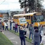 KEITH THORPE/PENINSULA DAILY NEWS
Friends, family and Roughrider fans line Race Street in front of Port Angeles Civic Field as a bus carrying the Port Angeles High School football team heads for Tumwater for Friday's state playoff opener. The Roughriders were on their first trip to state in more than a decade to play No. 1-seeded Tumwater High School. Dozens of people took part in the team sead-off.