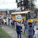 Friends, family and Roughrider fans line Race Street in front of Port Angeles Civic Field as a bus carrying the Port Angeles High School football team heads for Tumwater for Fridays state playoff opener. The Roughriders were on their first trip to state in more than a decade to play No. 1-seeded Tumwater High School. Dozens of people took part in the team send-off. (KEITH THORPE/PENINSULA DAILY NEWS)