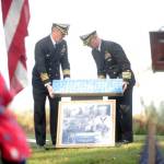 Capt. Brent Paul, left, and Capt. Benjamin Leppard of Naval Facilities Engineering Systems Command Northwest lead the annual Veterans Day Remembrance Program at Gardiner Community Cemetery in honor of Medal of Honor recipient construction mechanic third class Marvin G. Shields on Saturday. Shields is the only Navy Seabee to have received the Medal of Honor. He was posthumously awarded the Medal of Honor for heroism above and beyond the call of duty in the Vietnam War. A native of Gardiner, Shields was buried with a Marine Corps honor guard at the Gardiner Cemetery on June 19, 1965. (Michael Dashiell/Olympic Peninsula News Group)