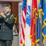 Rick Castellano of Whidbey Island sounds Taps at the conclusion of the 2023 Veterans Day celebration on Saturday at the Marvin G. Shields Memorial Post 26. (Steve Mullensky/for Peninsula Daily News)