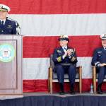 Cmdr. Brent Schmadeke, commanding officer of U.S. Coast Guard Air Station/Sector Field Office Port Angeles, left, introduces keynote speaker Capt. Holly Harrison of Coast Guard District 13, center, as Chaplain Mike VanProyen looks on during Saturdays Veterans Day program in Port Angeles. (Keith Thorpe/Peninsula Daily News)