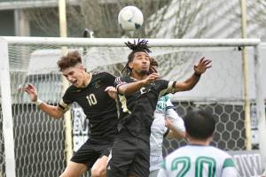 Peninsula Colleges Nil Grau, left, and Abdurahim Leigh battle for a ball in front of the Highline net Sunday in Tukwila. (Jay Cline/Peninsula College)