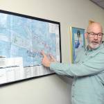 Jon Picker, airport and marina manager for the Port of Port Angeles, describes runway sections for William R. Fairchild International Airport on a diagram of the terminal area. (Keith Thorpe/Peninsula Daily News)