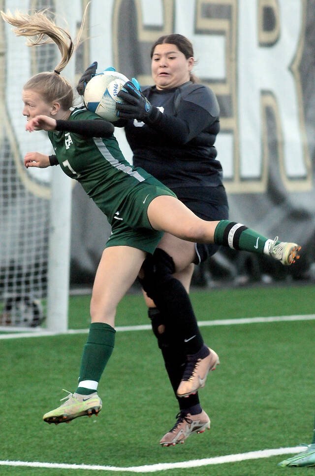Port Angeles Izzy Felton, left, attempts a header in the postseason against Renton, was named to the first team for the all-Olympic League girls soccer. Felton had eight goals on the season. (Keith Thorpe/Peninsula Daily News)