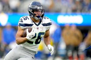 Seattle Seahawks running back Zach Charbonnet (26) runs the ball during the second half of an NFL football game against the Los Angeles Rams on Sunday in Inglewood, Calif. (Ashley Landis/The Associated Press)