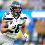 Seattle Seahawks running back Zach Charbonnet (26) runs the ball during the second half of an NFL football game against the Los Angeles Rams on Sunday in Inglewood, Calif. (Ashley Landis/The Associated Press)