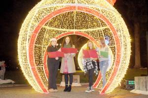 Singers, from left, Abbigail Cuellar, 16, Danielle Lorentzen of Ghostlight Productions, Kaylyn Stroup, 15, and Max MacFall, 15, perform a Christmas carol during Wednesday evenings opening ceremony for the 33rd annual Festival of Trees at Vern Burton Community Center in Port Angeles. (Keith Thorpe/Peninsula Daily News)