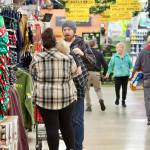 Shoppers look for bargains at Swains General Store in Port Angeles on Friday morning. On the left is Shawn Fowler, his wife Amber and their sleeping 2-year-old Cash. (Dave Logan/for Peninsula Daily News)