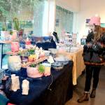 Melissa Montague of Corvallis, Ore., examines tables filled with locally-made gifts at the Makers Market on Friday at the Port Angeles Fine Arts Center. (KEITH THORPE/PENINSULA DAILY NEWS)