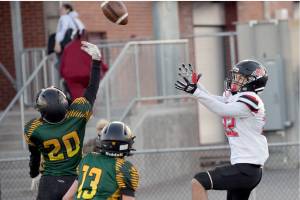 Neah Bay's Adan Ellis goes for a reception at the Apple Bowl in Wenatchee in the state 1B semifinal football game. Ellis had three touchdown catches in the game. Defending on the play are Liberty Bell's Bodie Thompson (20) and Greyden Paz (13). (Al Camp)