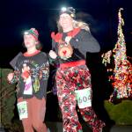 Sami Nolan, left, and Chelsea Pluard, both of Port Angeles, finish the 5K in the 2022 edition of the Jamestown SKlallam Glow Run in Blyn. The race returns Saturday afternoon and evening. (Run the Peninsula)