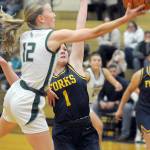 Port Angeles Izzy Felton, front, looks for the layup as Forks Bailey Johnson defends the lane on Tuesday night in Port Angeles. (Keith Thorpe/Peninsula Daily News)