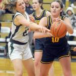 KEITH THORPE/PENINSULA DAILY NEWS Forks Avery Dilley, right, pulls down a rebound ahead of Port Angeles Becca Manson on Tuesday in Port Angeles.