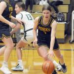 Forks Bailey Johnson, right, drives along the baseline as teammate Fynlie Peters, left, defends against Port Angeles Morgan Politika on Tuesday in Port Angeles. (Keith Thorpe/Peninsula Daily News)