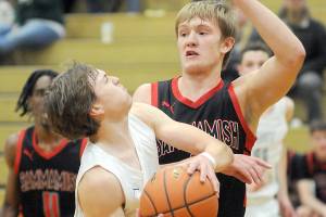 KEITH THORPE/PENINSULA DAILY NEWS
Port Angeles' Parker Nickerson, front, looks for the net as Sammamish's Barry Morrissette puts up a defense during Wednesday evening's game at Port Angeles High School.