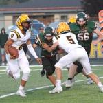 Forks quarterback and kick returner Bubba Hernandez (8) runs the ball in Forks against Morton-White Pass. (Lonnie Archibald/for Peninsula Daily News)