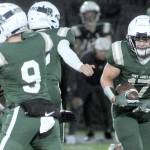 KEITH THORPE/PENINSULA DAILY NEWS
Port Angeles' Jason Hawes, right, picks an opening in the in the line after receiving a key block by teammate  Brandt Perry, left, during Friday's game against Bainbridge at Port Angeles Civic Field.