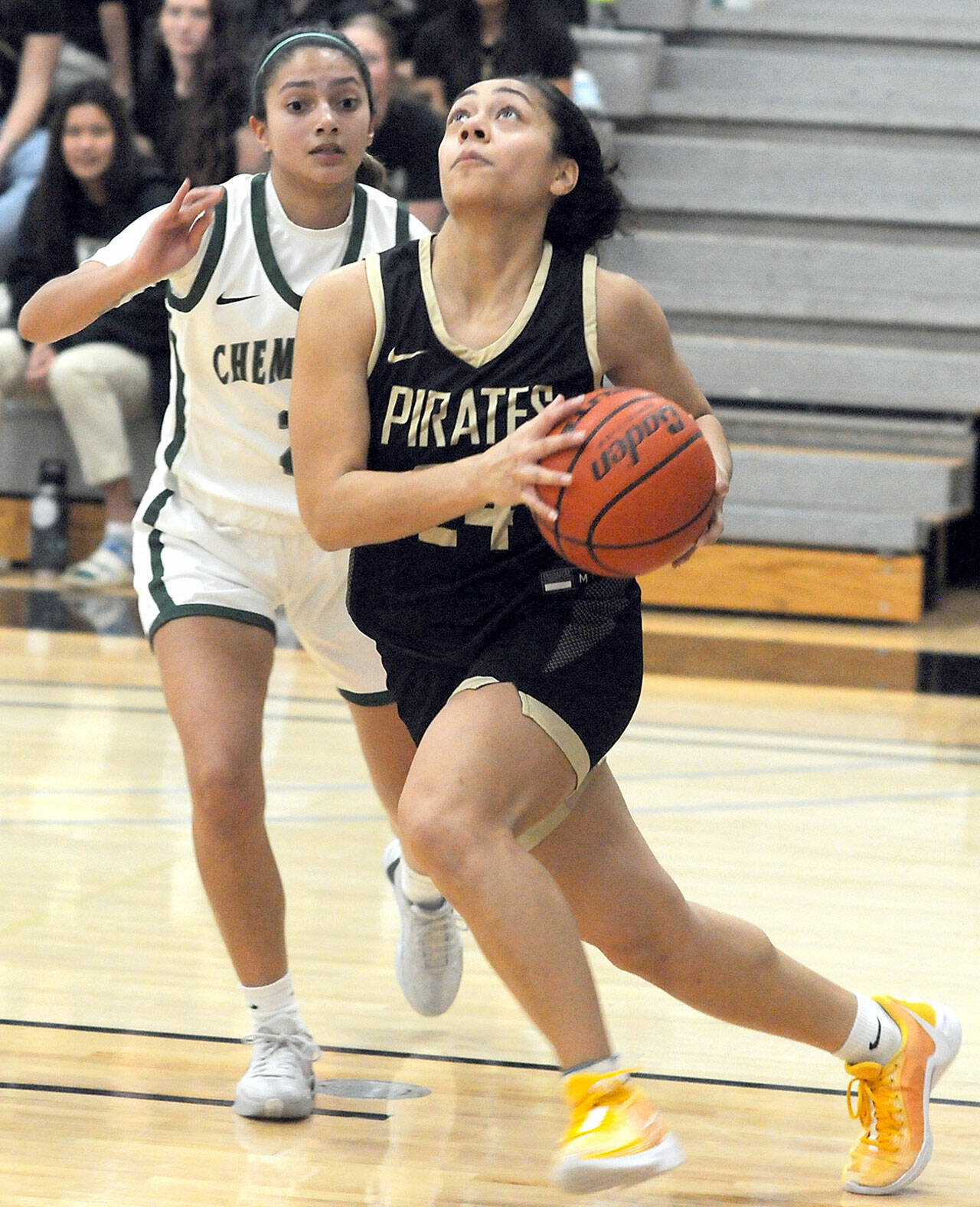 Peninsulas Shania Moananu, right, keeps an eye on the prize as she sweeps past Chemeketas Many Diaz during Saturdays rounds in the Pirate Classic in Port Angeles. (Keith Thorpe/Peninsula Daily News)