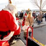 Dylan Kinney, 4, is introduced to Santa by her gran Debbie Hinton, both from Port Townsend, as Santa greeted kids on Saturday in downtown Port Townsend. (Steve Mullensky/for Peninsula Daily News)