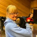 Kathy Coakley of Welfare for Animals Guild comforts one of the feral puppies caught on the Hoh Indian Reservation.