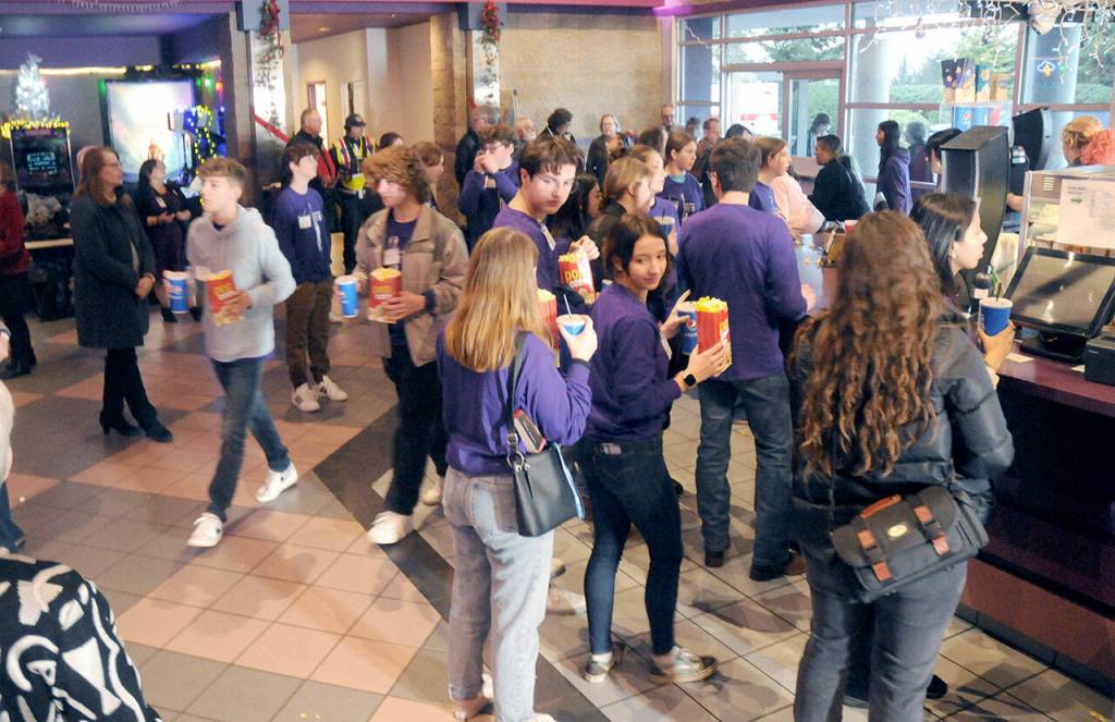 Sequim students line up for complementary concessions prior to Fridays special screening of The Boys in the Boat at Deer Park Cinemas in Port Angeles. (Keith Thorpe/Peninsula Daily News)