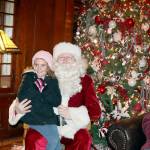 Kinsley Clemens, 6, of Port Angeles sits on Santas lap while family members take photos of the event. Santa got to visit many children who went to the Lake Crescent Lodge to enjoy the holiday spirit. (Dave Logan/for Peninsula Daily News)