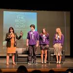 Sequim schools Superintendent Regan Nickels introduces past Interact Club members, from left, Ayden Humphries, Danika Chen and Ruby Coulson, who helped bring a screening of The Boys in the Boat to the area weeks before its release. (Matthew Nash/Olympic Peninsula News Group)