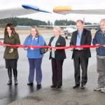 From left to right, Port of Port Angeles Commissioner Colleen McAleer, Ann Richart, the aviation director for the state Department of Transportation, Port Commissioner Connie Beauvais, Ryan Zulaul and Port Commissioner Steve Burke cut a ceremonial ribbon on Tuesday at Fairchild International Airport to celebrate the resurfacing of the runway. (Dave Logan/for Peninsula Daily News)