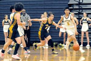 Forks Aidan Salazar drives up court against the Ilwaco defense on Wednesday night in the Spartan Gym where the Fishermen came from behind in the second half to defeat the Spartant 64-41. (Lonnie Archibald/for Peninsula Daily News)