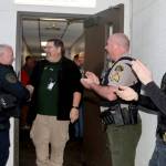 Ron Cameron goes through a friendly gauntlet of fellow employees with handshakes and hand claps on his way out off the courthouse for the last time as he is retiring. (DAVE LOGAN/FOR PENINSULA DAILY NEWS )