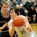 Port Angeles Parker Nickerson, right, charges past W.F. Wests Weston Potter during Tuesdays game at Port Angeles High School. (Keith Thorpe/Peninsula Daily News)