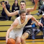 Port Angeles Isaiah Shamp, front, slides to the lane around W.F. Wests Parker Eiswald on Tuesday night in Port Angeles. (Keith Thorpe/Peninsula Daily News)