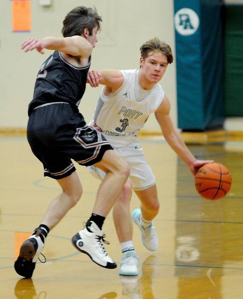 Port Angeles Blake Sohkberg, right, advances downcourt defended by W.F. Wests Lucas Hoff on Tuesday at Port Angeles High School.