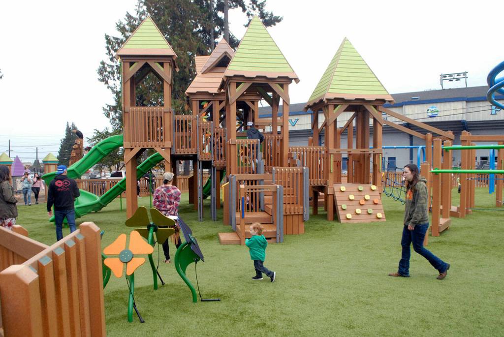 Children and parents roam through the Generation II Dream Playground at Erickson Playfield in Port Angeles on opening day in September 2021. (Keith Thorpe/Peninsula Daily News)