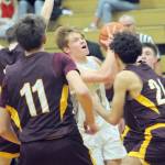Port Angeles Gus Halberg, center, looks for the net surrounded by Enumclaw defenders including, from left, Jason Feddema, Karson Holt and Liam Leonard on Wednesday in Port Angeles. (Keith Thorpe/Peninsula Daily News)
