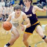 Port Angeles Parker Nickerson, left, eases past the defense of Enumclaws Wyatt Neu on Wednesday afternoon in Port Angeles. (Keith Thorpe/Peninsula Daily News)
