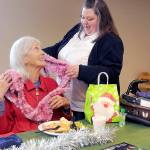 KEITH THORPE/PENINSULA DAILY NEWS
Marilyn Van Patter of Port Angeles, seated, is complimented on her decorative scarf by Capt. Crystal Birks of the Salvation Army of Port Angeles during Friday's pre-Christmas lunch at the corps facility. The meal included a clothing giveaway and gifts for participants. For information about free comunnity meals planned on Christmas Day, see Page A?