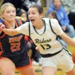 KEITH THORPE/PENINSULA DAILY NEWS
Port Angeles' Morgan Politika, right, charges to the key defended by Washougal's Ireland Albaugh on Thursday at Port Angeles High School.