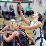 KEITH THORPE/PENINSULA DAILY NEWS Port Angeles Lindsay Smith, right looks for the easy layup as Washougals Avery Dixson, left, and Isabella Albaugh defend the lane during Thursdays game at Port Angeles High School.