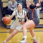 KEITH THORPE/PENINSULA DAILY NEWS Port Angeles Izzy Felton, left, drives past Washougals Ireland Abaugh on Thursday night in Port Angeles.