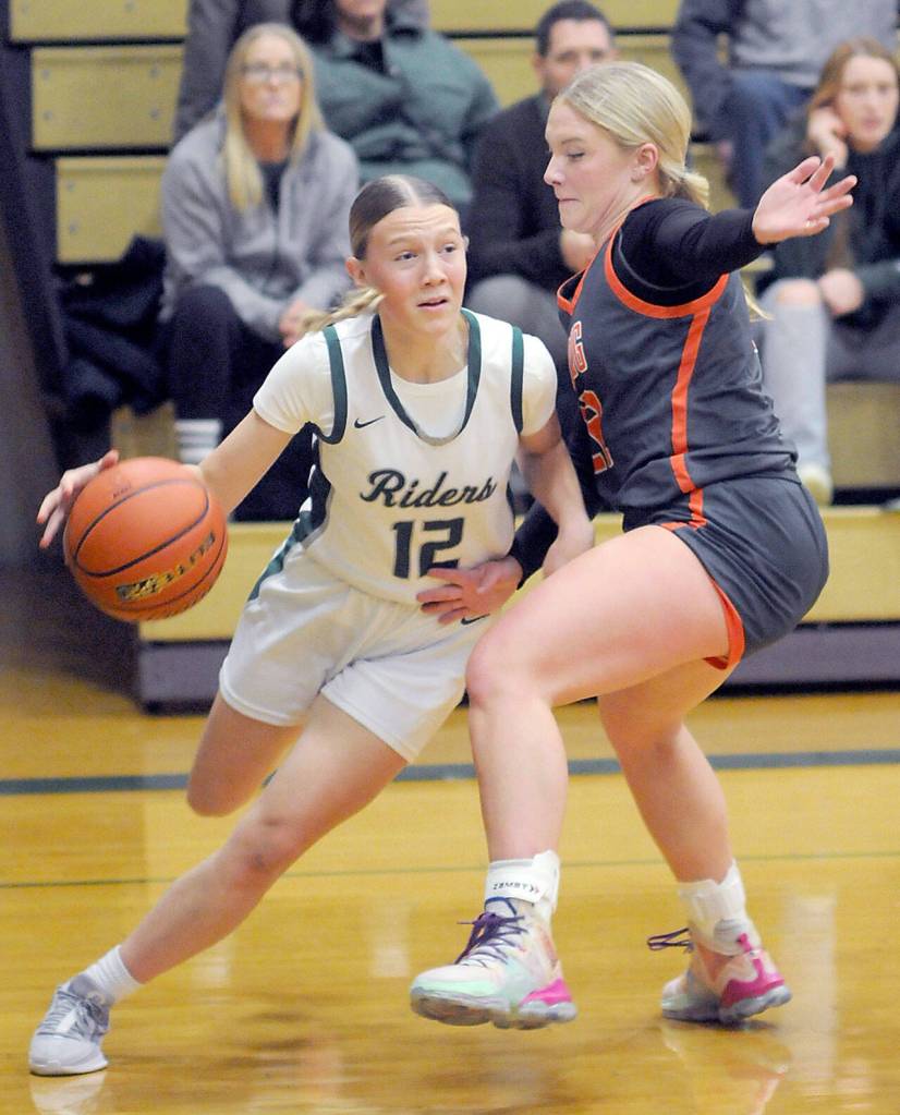 KEITH THORPE/PENINSULA DAILY NEWS Port Angeles Izzy Felton, left, drives past Washougals Ireland Abaugh on Thursday night in Port Angeles.