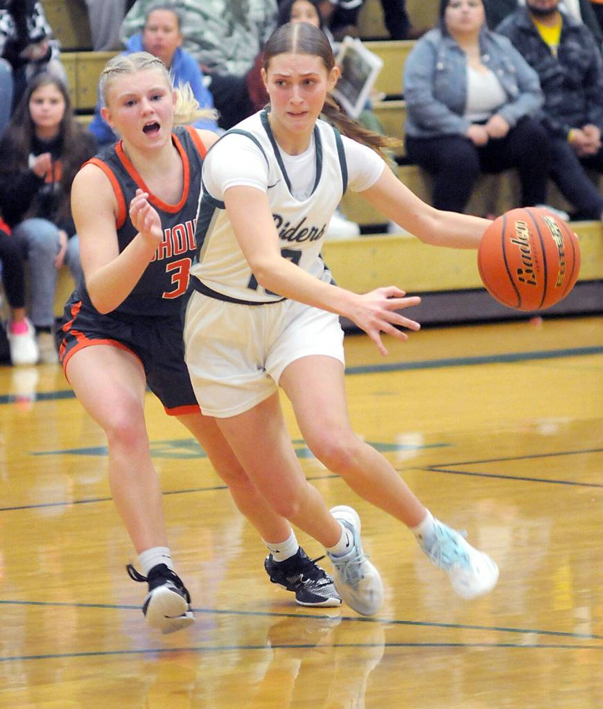 KEITH THORPE/PENINSULA DAILY NEWS Port Angeles Teanna Clark, right, slips around the defense of Washougals Addilyn Gibbons during Thursdays game in Port Angeles.
