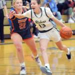 KEITH THORPE/PENINSULA DAILY NEWS Port Angeles Morgan Politika, right, charges to the key defended by Washougals Ireland Albaugh on Thursday at Port Angeles High School.
