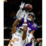 Washington cornerback Elijah Jackson (25) hits the ball before Texas wide receiver Adonai Mitchell (5) can catch it on the final play of the Sugar Bowl CFP NCAA semifinal college football game between Washington and Texas on Monday in New Orleans. Washington won 37-31. (AP Photo/Butch Dill)