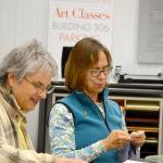 Glo Lamson, left, and a fellow artist worked on projects at a Northwind Art School open studio last year. Lamson will host another free creative studio this Saturday. (Northwind Art)